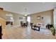 Open-concept living room with neutral walls, tile floors, and natural lighting at 4735 Red Pine Way, Wesley Chapel, FL 33545