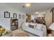 Inviting living area features a comfortable sofa, artwork, and an array of books on built-in shelving at 4735 Red Pine Way, Wesley Chapel, FL 33545