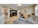 Open-concept living room with tile floors, featuring a cozy sofa, entertainment center, and seamless flow to other areas at 4735 Red Pine Way, Wesley Chapel, FL 33545