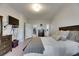 Comfortable main bedroom features a TV, dresser, and a doorway leading to the closet and main bathroom at 4735 Red Pine Way, Wesley Chapel, FL 33545