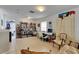 Spacious home office area with a built-in bookcase, large window, and comfortable seating for work and relaxation at 4735 Red Pine Way, Wesley Chapel, FL 33545