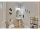 Stylish powder room with a pedestal sink and decorative accents at 4735 Red Pine Way, Wesley Chapel, FL 33545