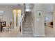 Carpeted staircase with white banister leads to the upper level of the home at 4735 Red Pine Way, Wesley Chapel, FL 33545
