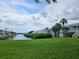 Beautiful waterfront view with lush green grass leading to the canal and neighboring condos at 4985 Cobia Se Dr # A, St Petersburg, FL 33705