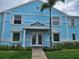 Charming light blue two-story condo with white trim, a brick pathway, and a well-manicured lawn at 4985 Cobia Se Dr # A, St Petersburg, FL 33705