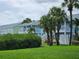 Charming pastel-colored condo buildings surrounded by lush greenery and palm trees on a sunny day at 4985 Cobia Se Dr # A, St Petersburg, FL 33705