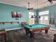 Community game room featuring a billiard table, television, and relaxing seating area at 4985 Cobia Se Dr # A, St Petersburg, FL 33705