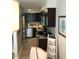 Efficient kitchen with dark cabinetry, granite countertops, and stainless steel appliances at 4985 Cobia Se Dr # A, St Petersburg, FL 33705