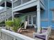 Private patio with outdoor seating, a brick floor, and access to the upper-level balcony at 4985 Cobia Se Dr # A, St Petersburg, FL 33705