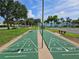 Dual shuffleboard courts featuring a classic design on a verdant lawn, inviting outdoor recreation and community engagement at 4985 Cobia Se Dr # A, St Petersburg, FL 33705