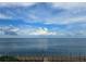 Expansive ocean view featuring a clear blue sky, calm waters, and a wooden pier at 4985 Cobia Se Dr # A, St Petersburg, FL 33705