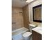 This bathroom features tiled walls with a stylish stripe, as well as a shower and storage niche at 502 Cara Ct # 502, Largo, FL 33771