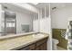 This bathroom features a large mirror with a marble countertop and wooden drawers at 502 Cara Ct # 502, Largo, FL 33771