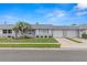 Charming townhome with a well-maintained lawn, mature palm trees, and an attached single car garage at 502 Cara Ct # 502, Largo, FL 33771
