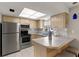 Well-lit kitchen with stainless steel appliances and ample counter space at 502 Cara Ct # 502, Largo, FL 33771