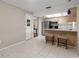 Bright kitchen features stainless steel appliances, laminate countertops, and bar seating at 502 Cara Ct # 502, Largo, FL 33771
