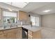 This kitchen features laminate countertops, and a stainless steel dishwasher, with sliding door access to another room at 502 Cara Ct # 502, Largo, FL 33771