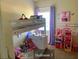 bedroom features a bunk bed, toys, and purple curtains creating a colorful and playful space at 5139 Corvette Dr, Tampa, FL 33624