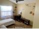 Bright bedroom offering a cozy single bed, study desk, neutral paint, and shelving for organization and decor at 5139 Corvette Dr, Tampa, FL 33624