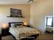 Comfortable main bedroom featuring a large bed, dark furniture, neutral colors and natural light from the window at 5139 Corvette Dr, Tampa, FL 33624