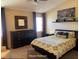 Comfortable main bedroom featuring a large bed, dark furniture, neutral colors and natural light from the window at 5139 Corvette Dr, Tampa, FL 33624
