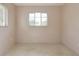 A cozy bedroom with neutral walls, terrazzo floors, and a bright window offering natural light at 5221 48Th N Ave, St Petersburg, FL 33709