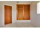 Bedroom featuring a built-in closet with louvered doors, wood closet door, and terrazzo floors at 5221 48Th N Ave, St Petersburg, FL 33709