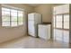 Functional kitchen area with a full-size refrigerator and adjacent cabinet storage at 5221 48Th N Ave, St Petersburg, FL 33709