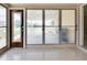 Enclosed sunroom featuring jalousie windows and terrazzo flooring, offering a bright and airy space at 5221 48Th N Ave, St Petersburg, FL 33709