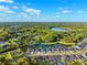 Stunning aerial view of the property showcasing the lake and lush green landscape at 6035 Nikki Ln, Odessa, FL 33556