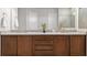 Elegant bathroom featuring double sinks, granite countertops, and wood cabinets at 6035 Nikki Ln, Odessa, FL 33556