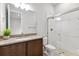 Bright bathroom featuring granite counters, walk-in shower and wood cabinetry at 6035 Nikki Ln, Odessa, FL 33556