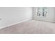 Bright, carpeted bedroom with baseboards and natural light at 6035 Nikki Ln, Odessa, FL 33556