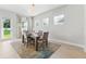 Bright dining room with a stylish table set for four, complemented by a colorful rug and natural light at 6035 Nikki Ln, Odessa, FL 33556