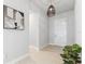 Welcoming entryway features neutral paint, tile flooring, and stylish light fixture at 6035 Nikki Ln, Odessa, FL 33556