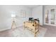 Bright home office offers a work-from-home space with a modern desk, stylish rug, and floor lamp at 6035 Nikki Ln, Odessa, FL 33556