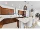 Beautiful kitchen featuring dark wood cabinets, stainless steel appliances, and a large island with white quartz countertops at 6035 Nikki Ln, Odessa, FL 33556