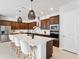 Gourmet kitchen features stainless steel appliances, dark wood cabinets and an island with breakfast bar at 6035 Nikki Ln, Odessa, FL 33556