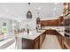 Gourmet kitchen with stainless steel appliances, dark wood cabinets and an island with breakfast bar at 6035 Nikki Ln, Odessa, FL 33556