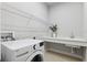 Laundry room with utility sink, wire shelf and washer at 6035 Nikki Ln, Odessa, FL 33556