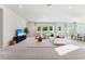 Spacious living room featuring carpeted floors, neutral paint, and a view of the backyard at 6035 Nikki Ln, Odessa, FL 33556