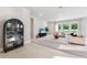 Bright living room with neutral colors, large windows, plush carpet and stylish furnishings at 6035 Nikki Ln, Odessa, FL 33556