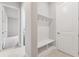 Mud room featuring built in seating and storage and a view to the laundry room at 6035 Nikki Ln, Odessa, FL 33556