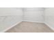 Spacious walk-in closet with ample shelving and carpeted floor for organized storage at 6035 Nikki Ln, Odessa, FL 33556