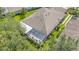 This home features a screened patio, a neutral toned roof, and mature trees providing shade and privacy at 6041 Sandhill Ridge Dr, Lithia, FL 33547