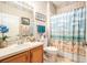 Bathroom featuring beach themed decor, vanity with sink, toilet and shower with themed curtain at 6041 Sandhill Ridge Dr, Lithia, FL 33547