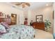Comfortable bedroom with floral bedding, carpet, and ceiling fan at 6041 Sandhill Ridge Dr, Lithia, FL 33547