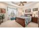 Comfortable bedroom with tray ceiling, ceiling fan and large window at 6041 Sandhill Ridge Dr, Lithia, FL 33547