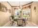 Charming dining room with elegant wallpaper, a decorative chandelier, and views from surrounding windows at 6041 Sandhill Ridge Dr, Lithia, FL 33547