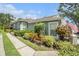 Charming home with a well-manicured lawn and colorful landscaping, showcasing its inviting curb appeal at 6041 Sandhill Ridge Dr, Lithia, FL 33547